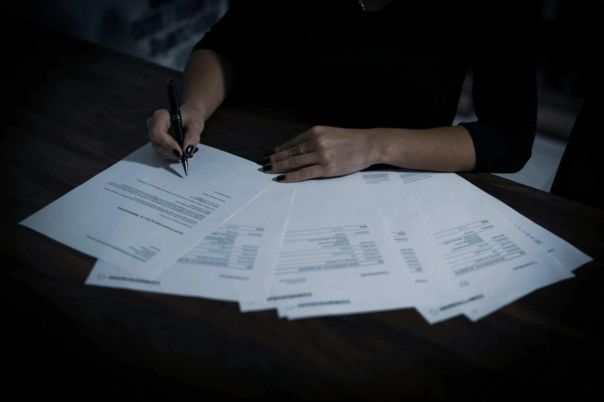 Professional reviewing and signing paper documents for editing services